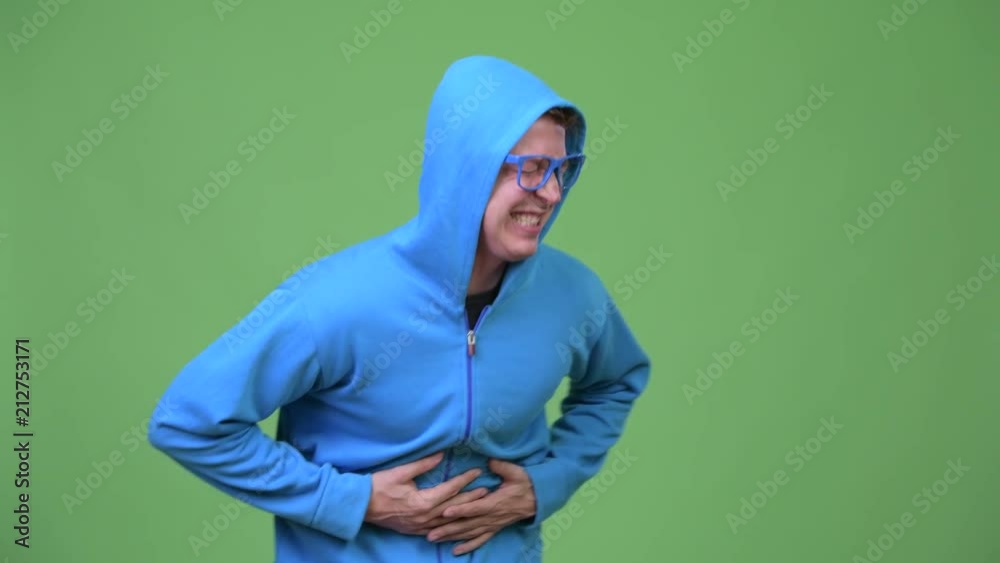 Young handsome nerd man having stomach ache Young handsome nerd man having stomach ache
