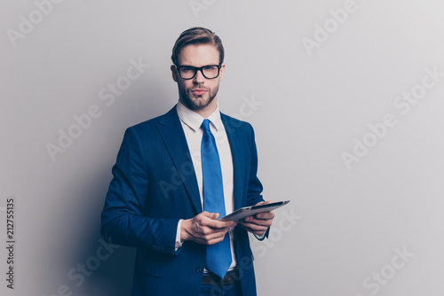 Marketer career success expert qualified people person touchscreen concept. Portrait of serious smart strict confident stylish banker using holding tablet in hands isolated gray background copy-space