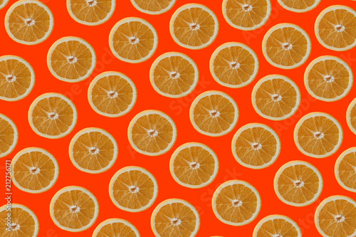 Many juicy oranges lie on the colored surface. Orange background