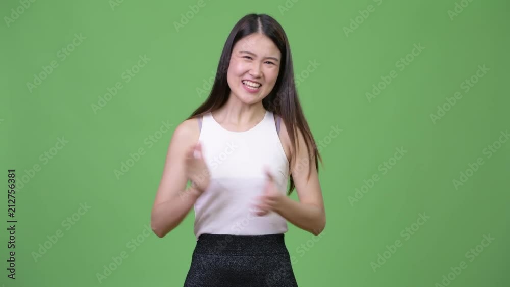 Young beautiful Asian businesswoman clapping hands Young beautiful Asian businesswoman clapping hands