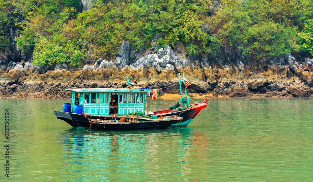 A fishing boat in the bay, Halong, Vietnam. Copy space for text. A fishing boat in the bay, Halong, Vietnam. Copy space for text.