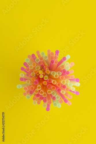 Creative view of drinking straws(neon colors) party on yellow background.