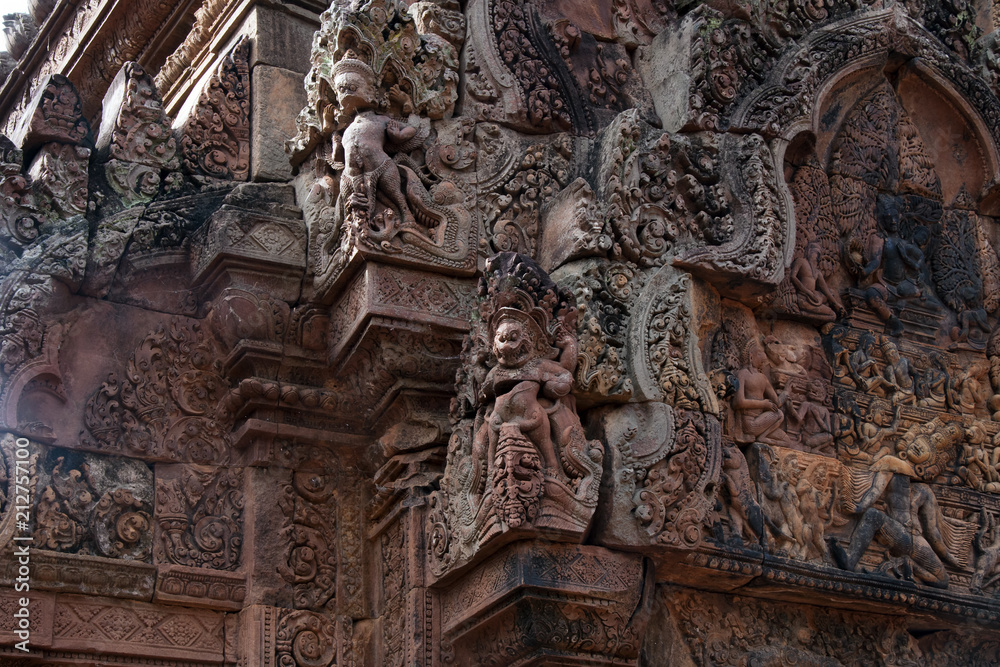 Angkor Cambodia, carvings of garuda and east facing pediment with Siva seated on the summit of Mount Kailasa on southern library at the 10th century Banteay Srei temple