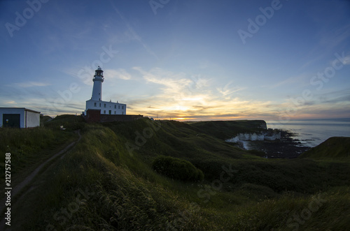 Coastal Landscape with Lighthouse at Sunset