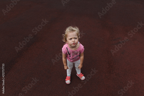 capricious little girl on a dark red background