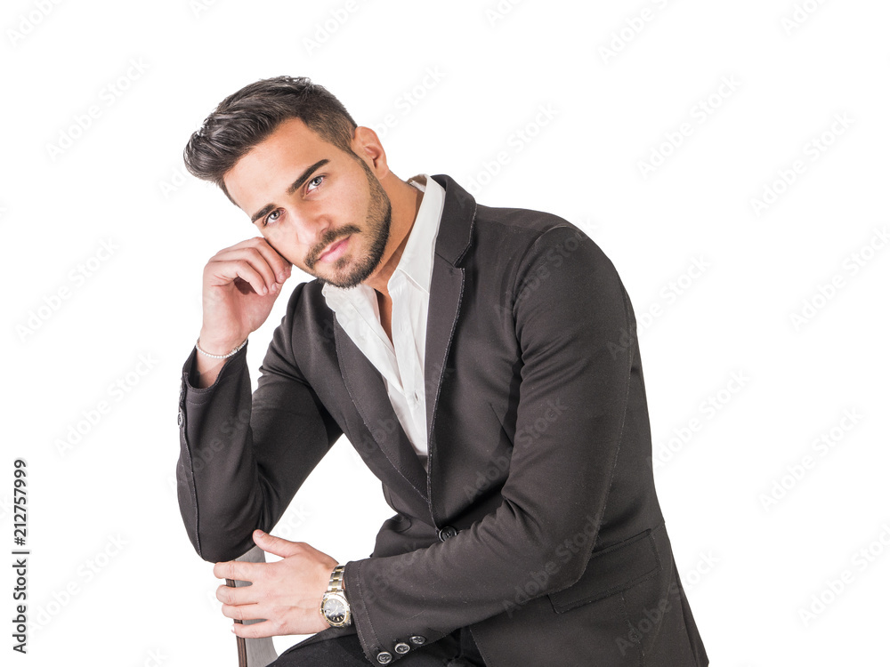 A different kind of young business man wearing business suit, isolated on light background, sitting A different kind of young business man wearing business suit, isolated on light background, sitting
