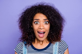 Head shot portrait of crazy mad girl with wide open mouth eyes yelling loudly isolated on violet background