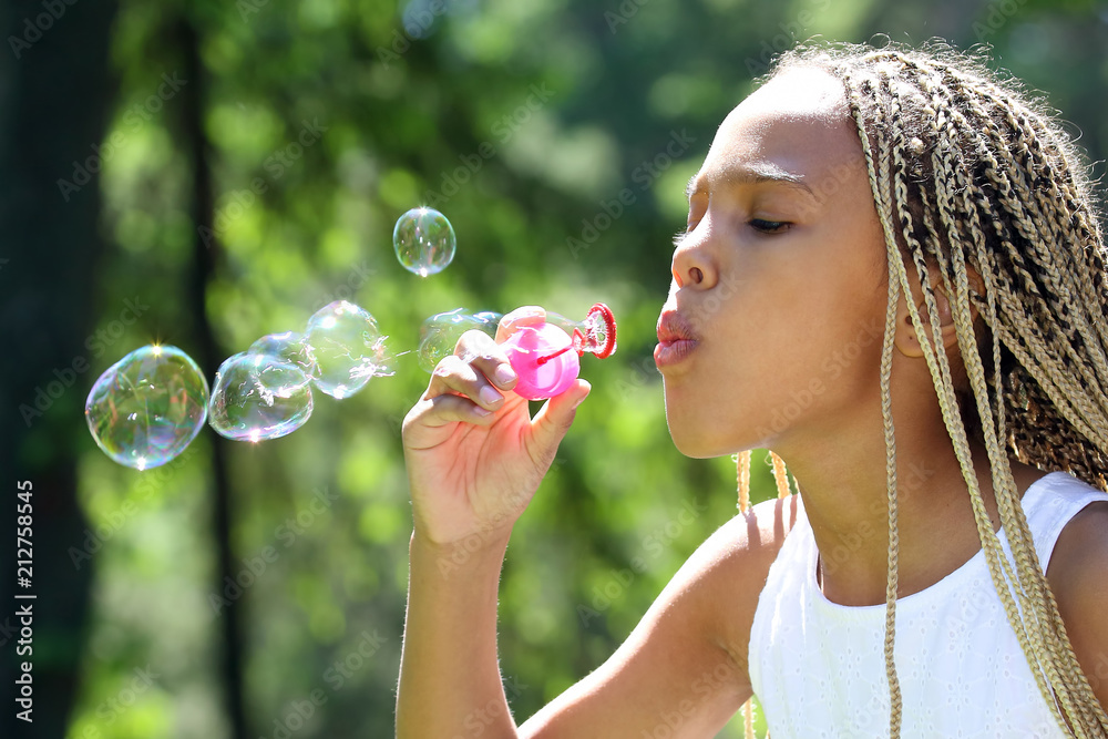 the girl with the long pigtails blow bubbles