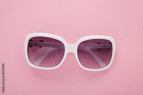 Summer background. Sunglasses isolated on colorful background. Top view and copy space.