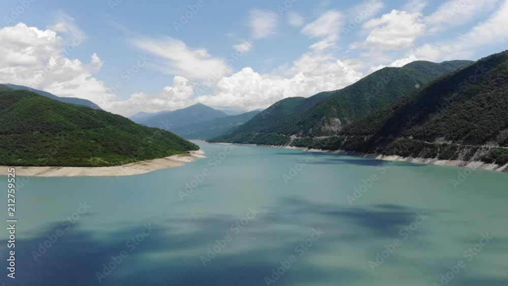 Aerial photography of a blue lagoon surrounded by green hills, a beautiful clear sky. 4k Aerial photography of a blue lagoon surrounded by green hills, a beautiful clear sky. 4k