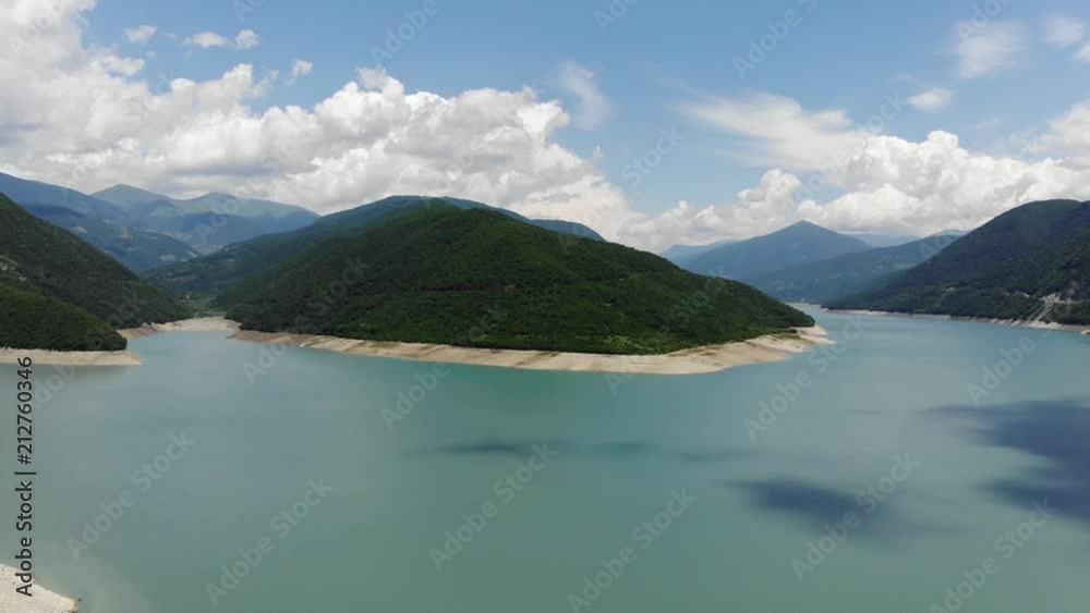 Aerial photography of a blue lagoon surrounded by green hills, a beautiful clear sky. 4k Aerial photography of a blue lagoon surrounded by green hills, a beautiful clear sky. 4k