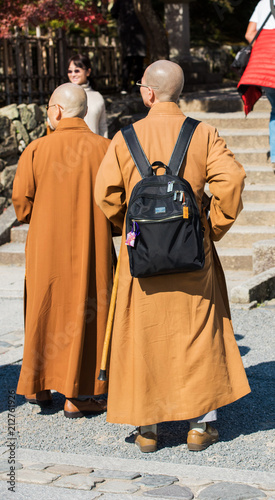 KYOTO, JAPAN - NOVEMBER 7, 2017: Monks on the territory of the temple. Vertical. Back view..