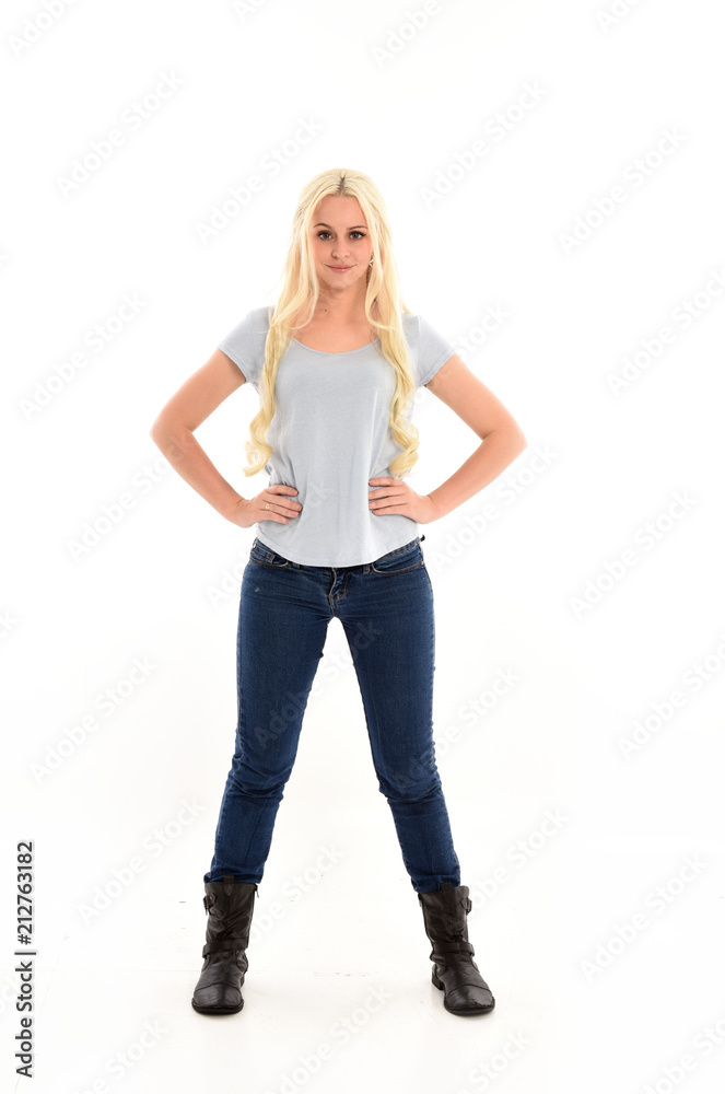 full length portrait of blonde girl wearing blue shirt and jeans, standing pose isolated on white studio background. full length portrait of blonde girl wearing blue shirt and jeans, standing pose isolated on white studio background.