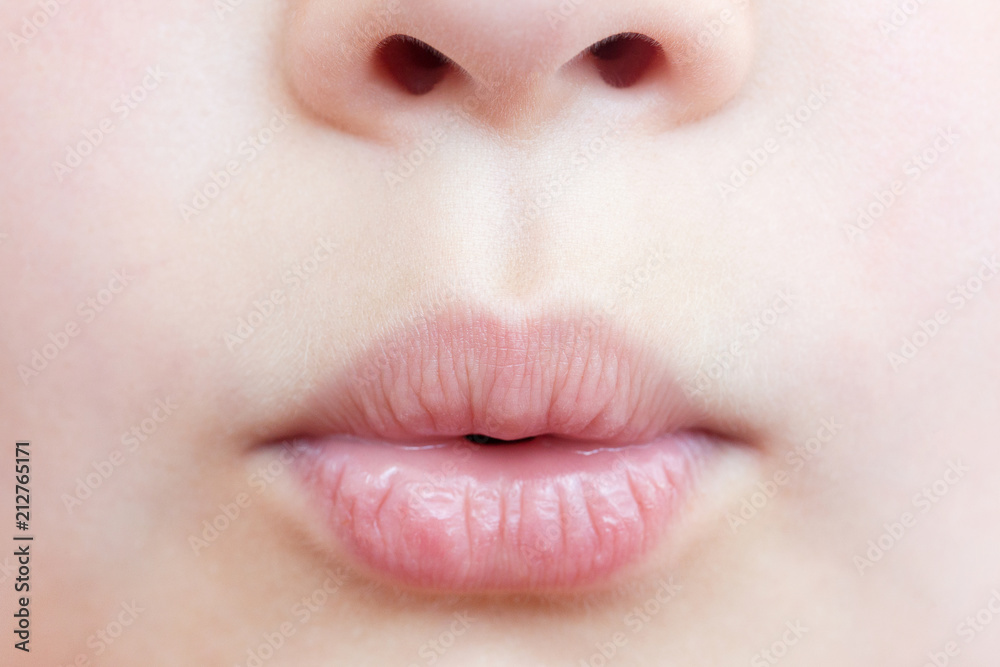 Naklejka premium Smiling child close-up. Lips close-up.