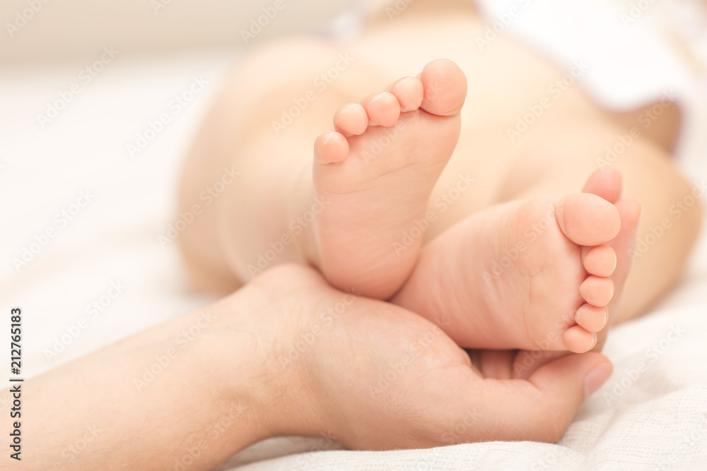 Little baby legs in daddy's hands. Little baby legs in daddy's hands.