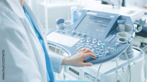 In the Hospital  Obstetrician Pushes Buttons on a Control Panel Before Starting Ultrasound   Sonogram Procedure.