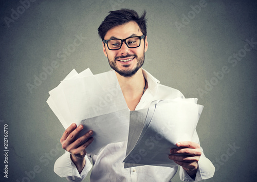 Konstfotografi Cheerful beard man reading papers