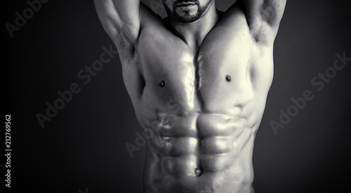 Naked breast. Male body. Tanned, perfect skin of seductive male model. Six pack abs and well trained chest muscules. Man's ideal body shape. Striptease theme and entertainment. Skin care for men