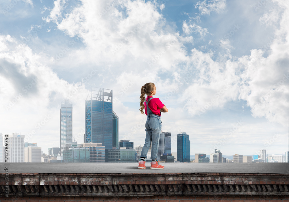 Concept of careless happy childhood with girl looking far away Concept of careless happy childhood with girl looking far away