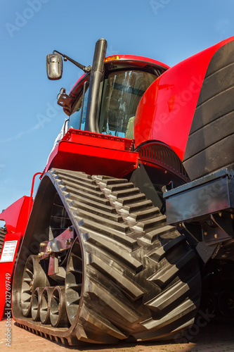 Tractor for farm work, modern agricultural transport working in the field, modern tractor close-up photo