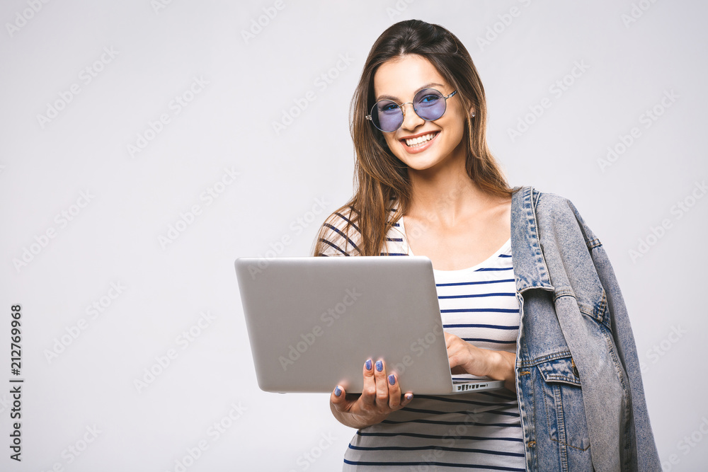 Portrait of happy young beautiful smiling woman standing with laptop isolated on white background. Space for text. Portrait of happy young beautiful smiling woman standing with laptop isolated on white background. Space for text.