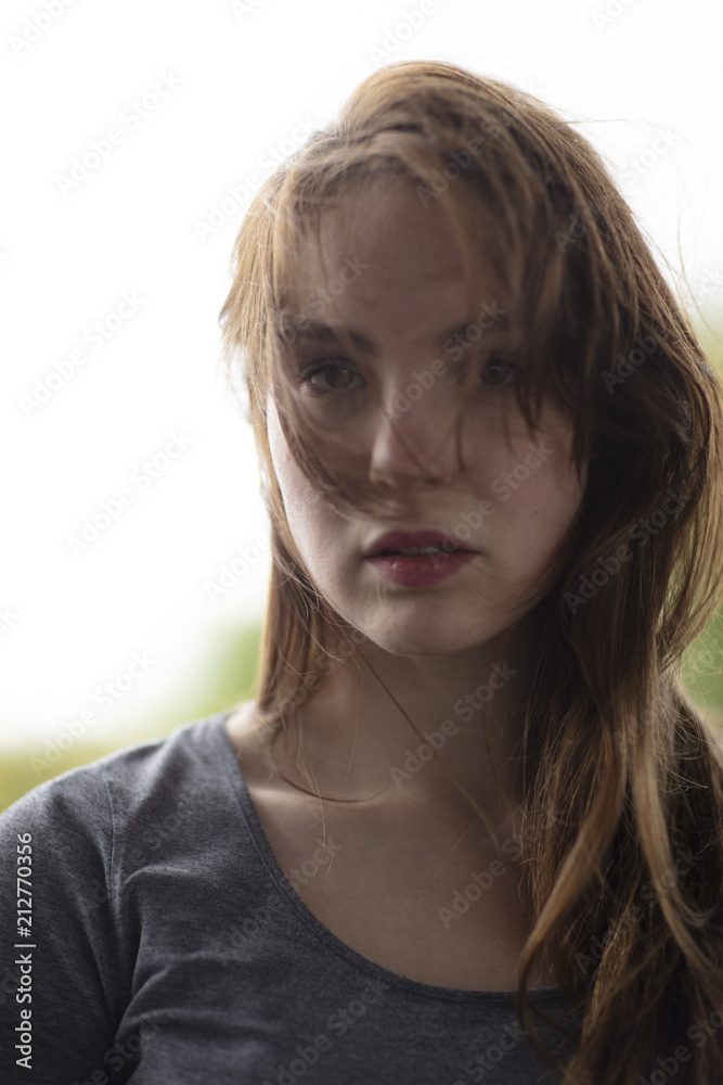 Young Attractive Woman With Hair Falling on Face Looking at the Camera Young Attractive Woman With Hair Falling on Face Looking at the Camera
