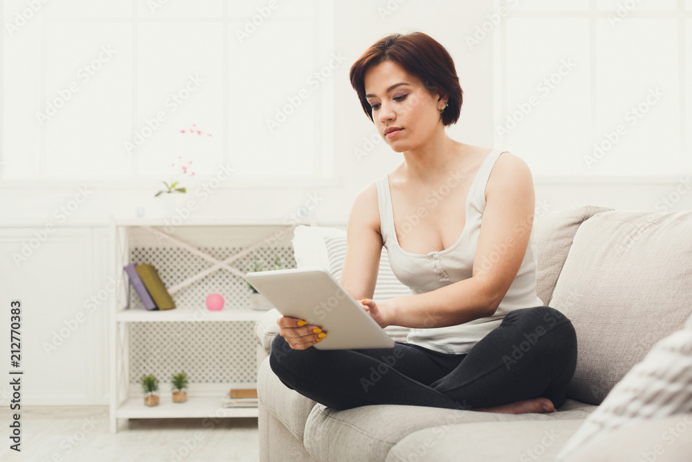 Young girl with a tablet at home Young girl with a tablet at home