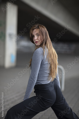 Rear View of Female Dancer Looking Towards Camera in Dance Pose