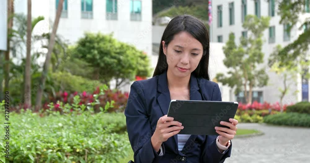 Asian Businesswoman use of digital tablet computer at outdoor