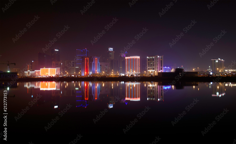A beautiful view of Bahrain skyline during night and its reflection on water