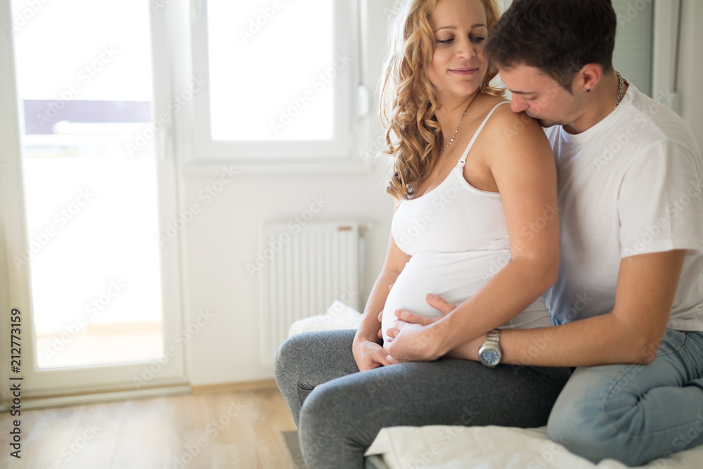 Happy pregnant woman relaxing with her husband Happy pregnant woman relaxing with her husband