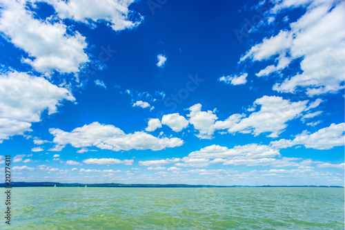 Fototapeta Naklejka Na Ścianę i Meble -  Summer green water lake with cloudy blue sky