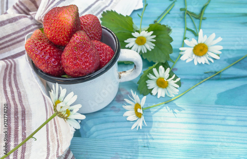 close up view of mug of ripe starwberries photo