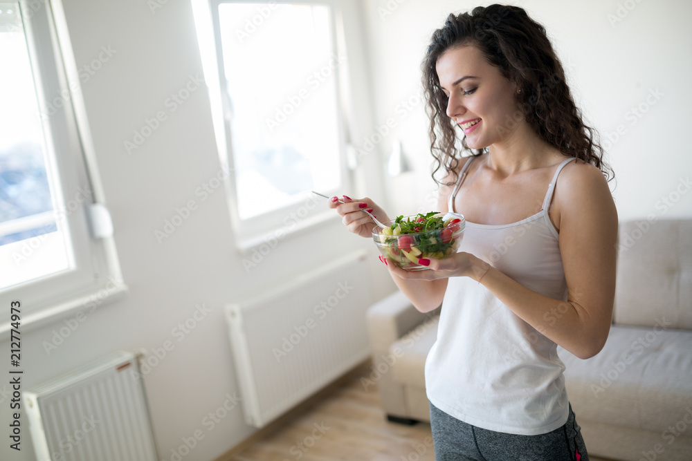 Fitness woman eating healthy food after workout Fitness woman eating healthy food after workout