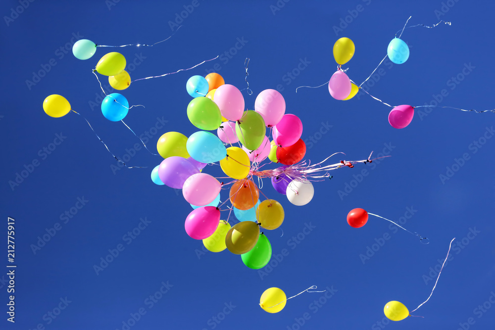 many multicolored balloons flying in the blue sky many multicolored balloons flying in the blue sky