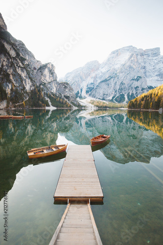 Obraz na płótnie Traditional rowing boats at Lago di Braies at sunrise in fall, South Tyrol, Italy w salonie