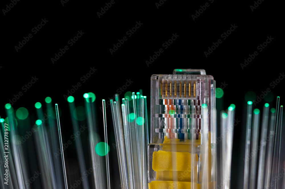 Yellow internet switch, green optical fibres close up macro shot on black background. Yellow internet switch, green optical fibres close up macro shot on black background.