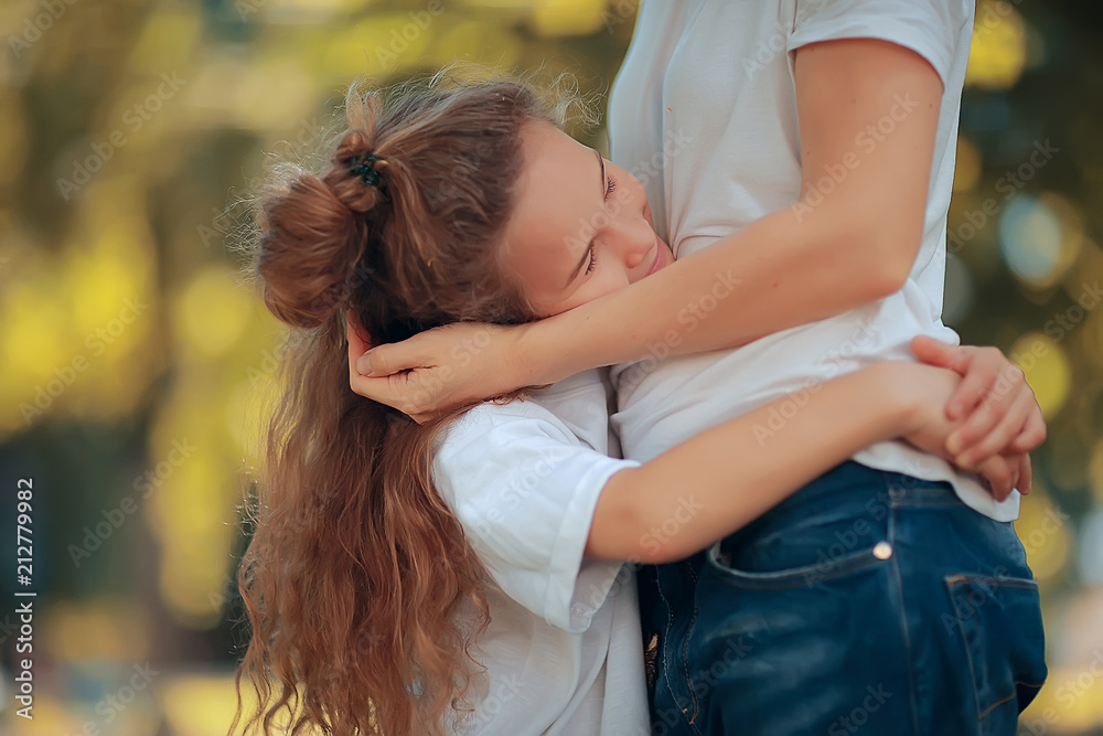 Naklejka premium daughter kisses mom / happy family mom and daughter kiss, concept of female happiness, beautiful mother and daughter 5 year old kiss