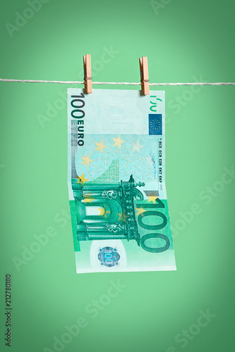 a 100 euro banknote dries on a rope