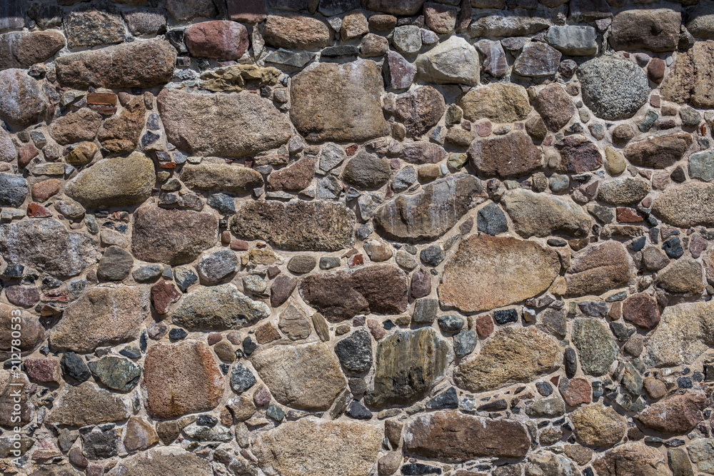 the wall of an old building lined with stones the wall of an old building lined with stones