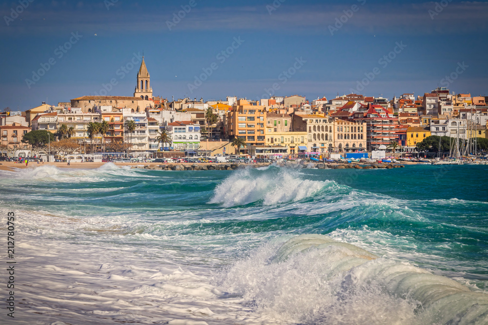 Naklejka premium Beautiful Spanish village Palamos in Costa Brava with big waves