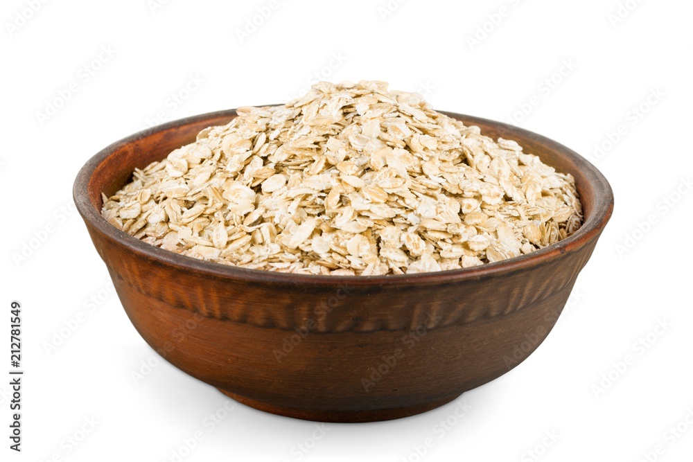 the oat flakes on a wooden spoon the oat flakes on a wooden spoon