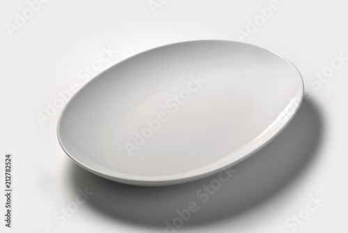 Isolated empty white oval plate