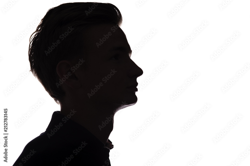 silhouette of an unrecognizable guy, man face profile on a white isolated background