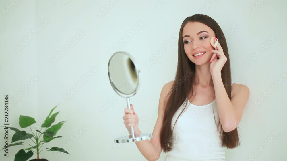 Beauty and Care. Woman Applying Cream On Skin. Beautiful Young Woman with Clean Fresh Skin touch her face . Facial treatment . Cosmetology , beauty and spa Beauty and Care. Woman Applying Cream On Skin. Beautiful Young Woman with Clean Fresh Skin touch her face . Facial treatment . Cosmetology , beauty and spa