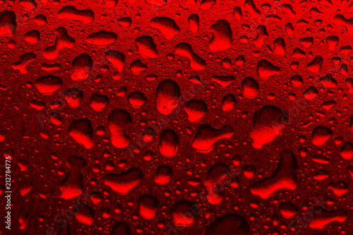 Red background with water droplets close-up. Horizontal photo