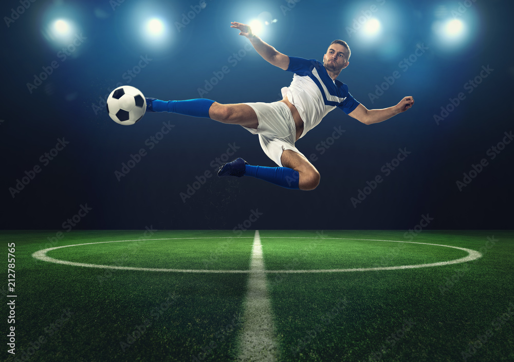 Soccer striker hits the ball with an acrobatic kick Soccer striker hits the ball with an acrobatic kick