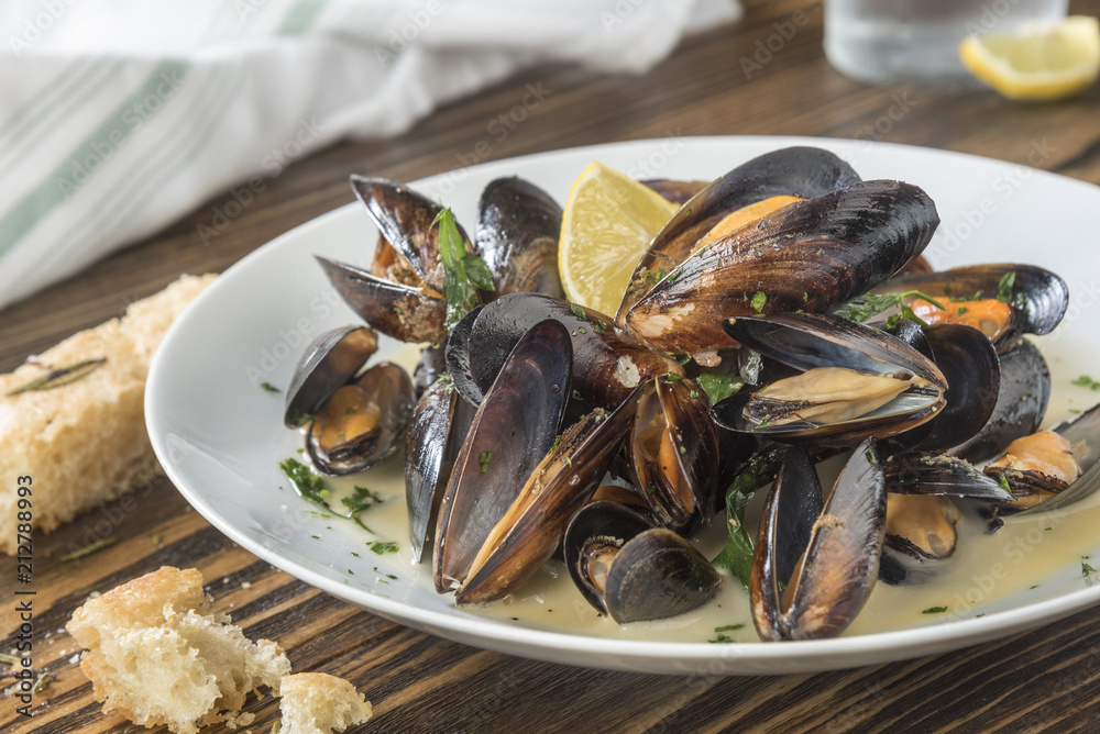 Mussels cooked with lemon and white wine. Seafood plate specialty of both France and Belgium Mussels cooked with lemon and white wine. Seafood plate specialty of both France and Belgium