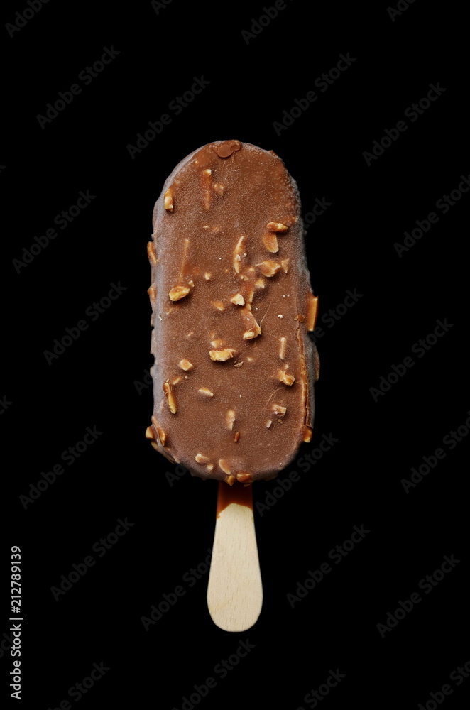 Chocolate ice lolly with almonds on the black isolated background. Ice cream bar,summer hot day. Cold yummy ice cream .Ice cream concept background. Chocolate ice lolly with almonds on the black isolated background. Ice cream bar,summer hot day. Cold yummy ice cream .Ice cream concept background.