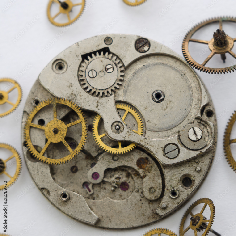 Vintage broken clockwork  on the white background. Scattered mechanisms.Macro Mechanical Gear Background